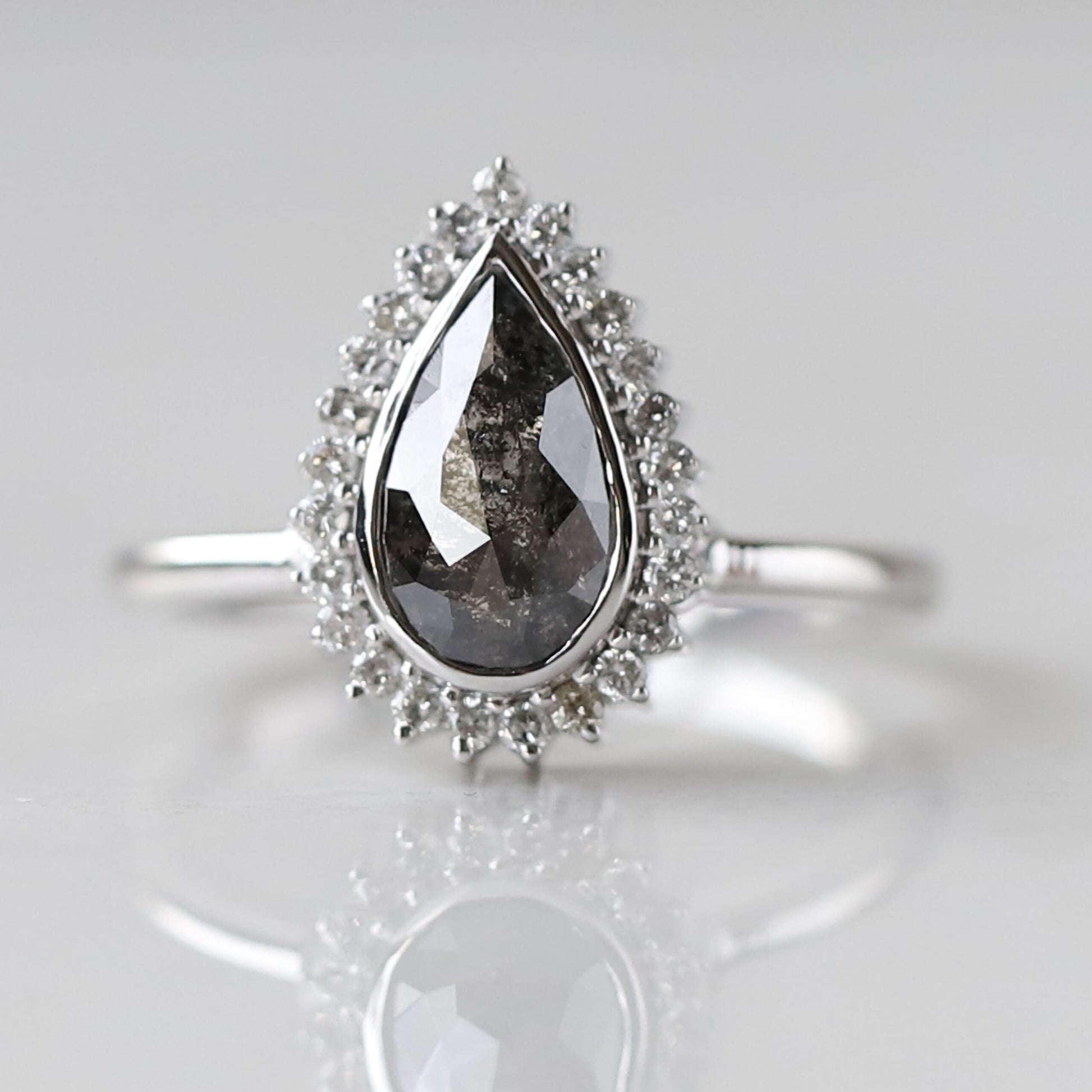 Pear shaped salt and pepper diamond engagement ring