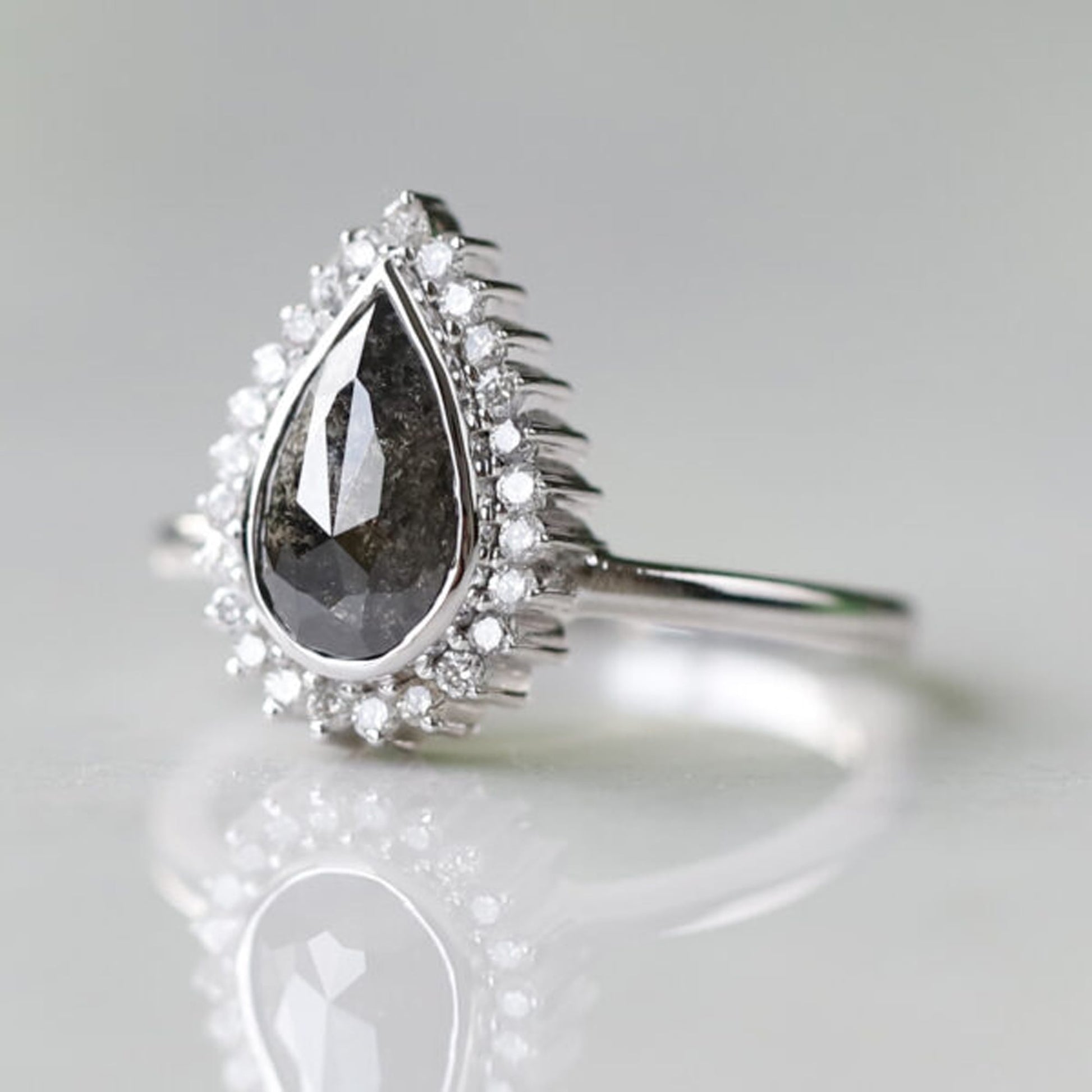Unique pear shaped salt and pepper diamond ring
