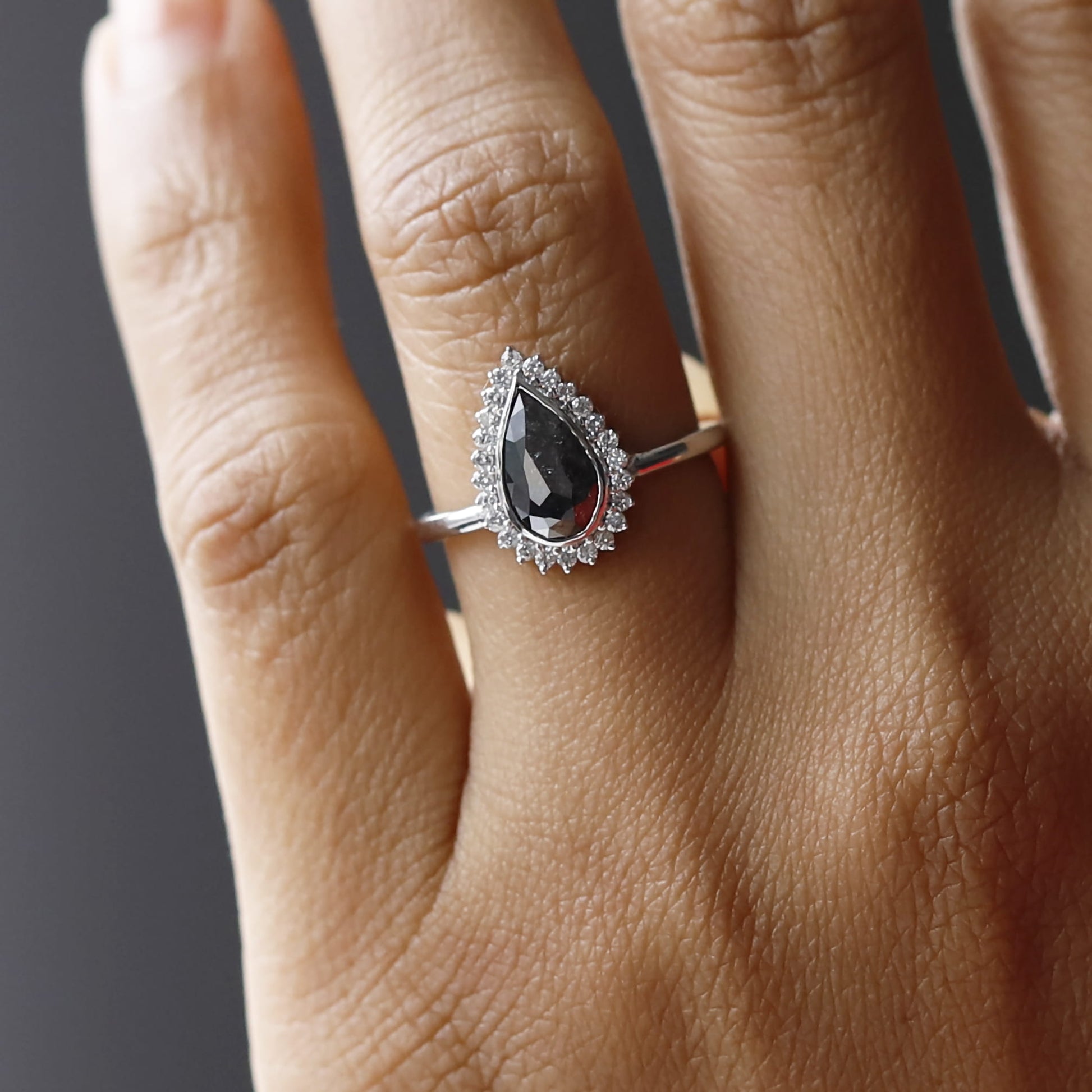 Elegant pear shaped salt and pepper diamond ring