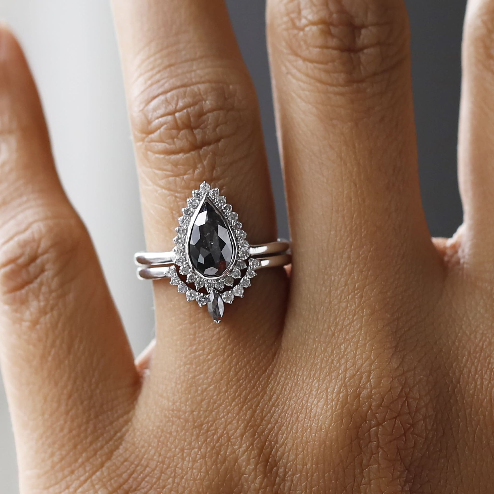 Romantic pear shaped salt and pepper diamond engagement ring