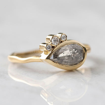 Close-up of pear salt and pepper diamond ring showcasing its inclusions